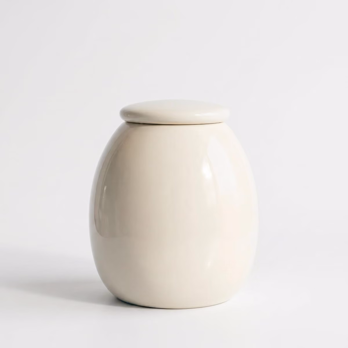 Cherry Blossom pet urn shown next to a hand for scale