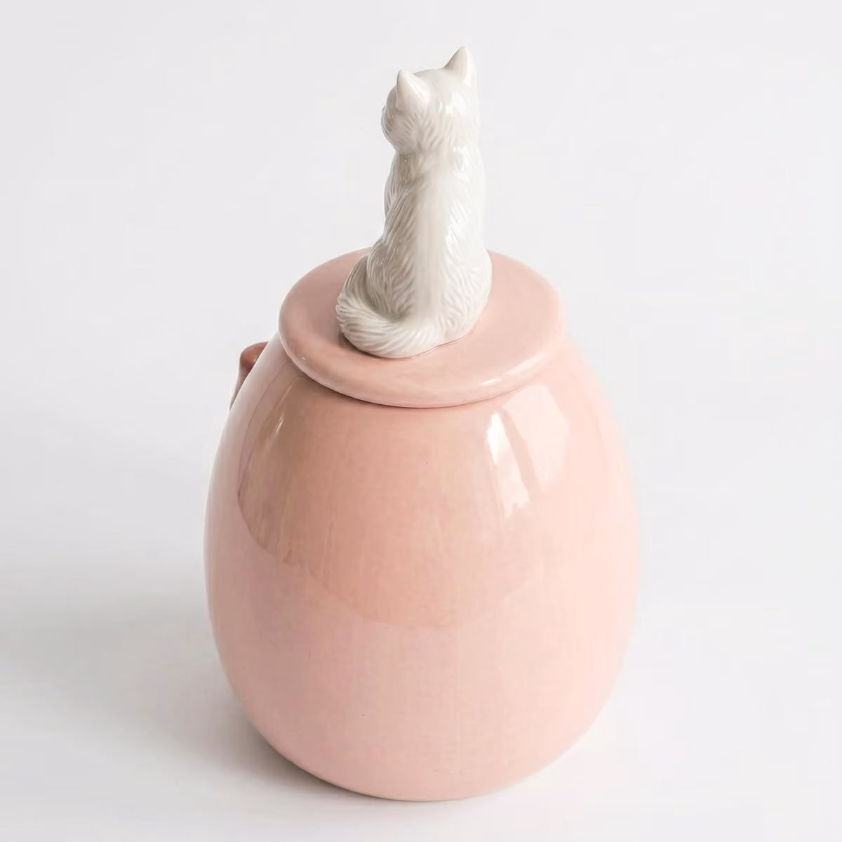Close-up of the heart & bow detail on a handmade ceramic urn