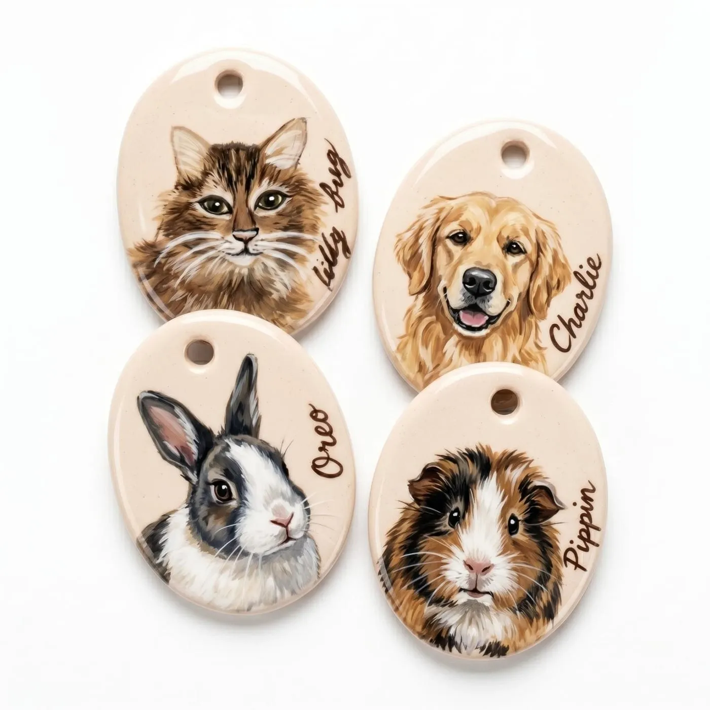 Four oval hand-painted ceramic pendants showing a tabby cat, a golden retriever, a rabbit and a guinea pig, each with the pet's name written beside the portrait