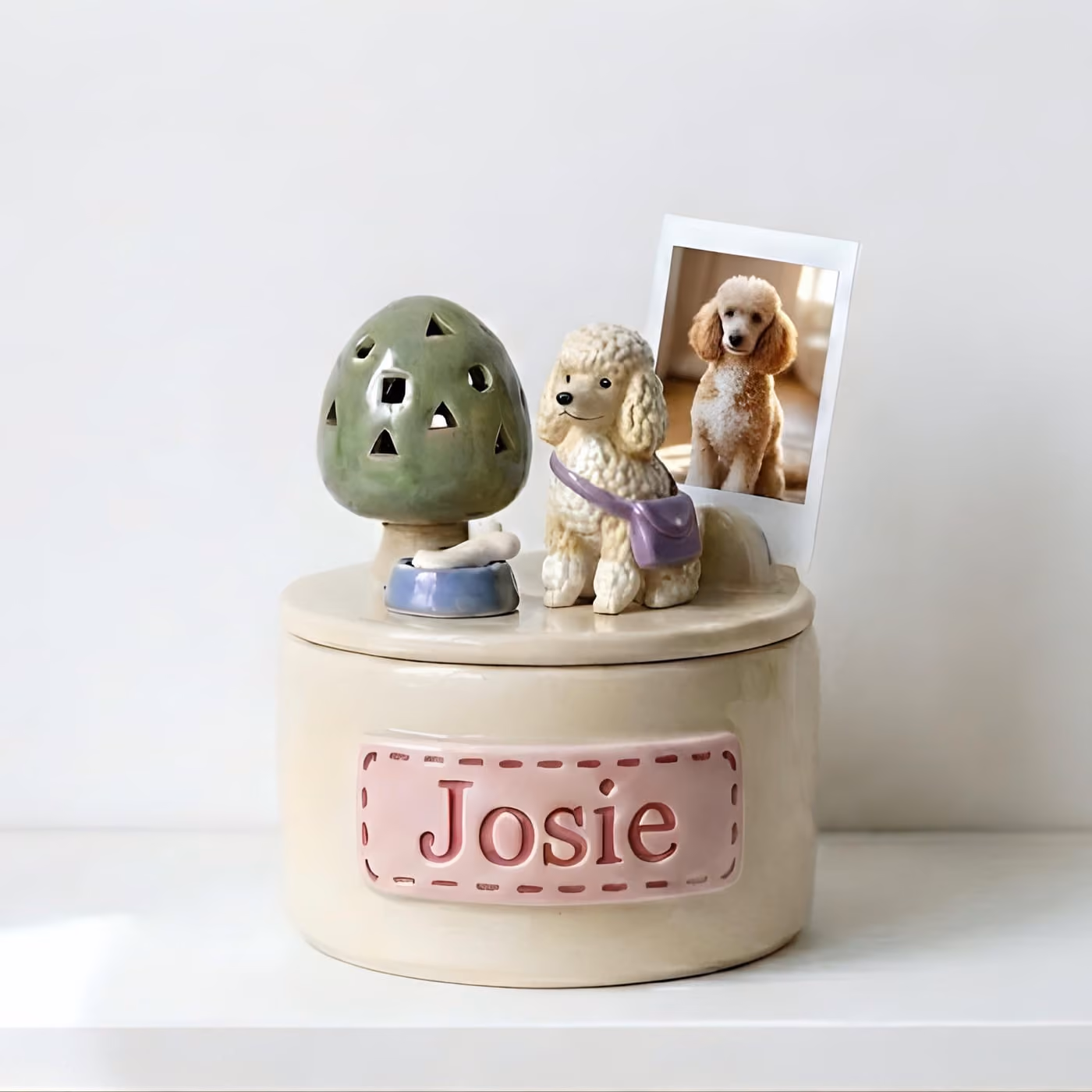 Handmade ceramic pet memorial urn with a hand-sculpted pet figurine