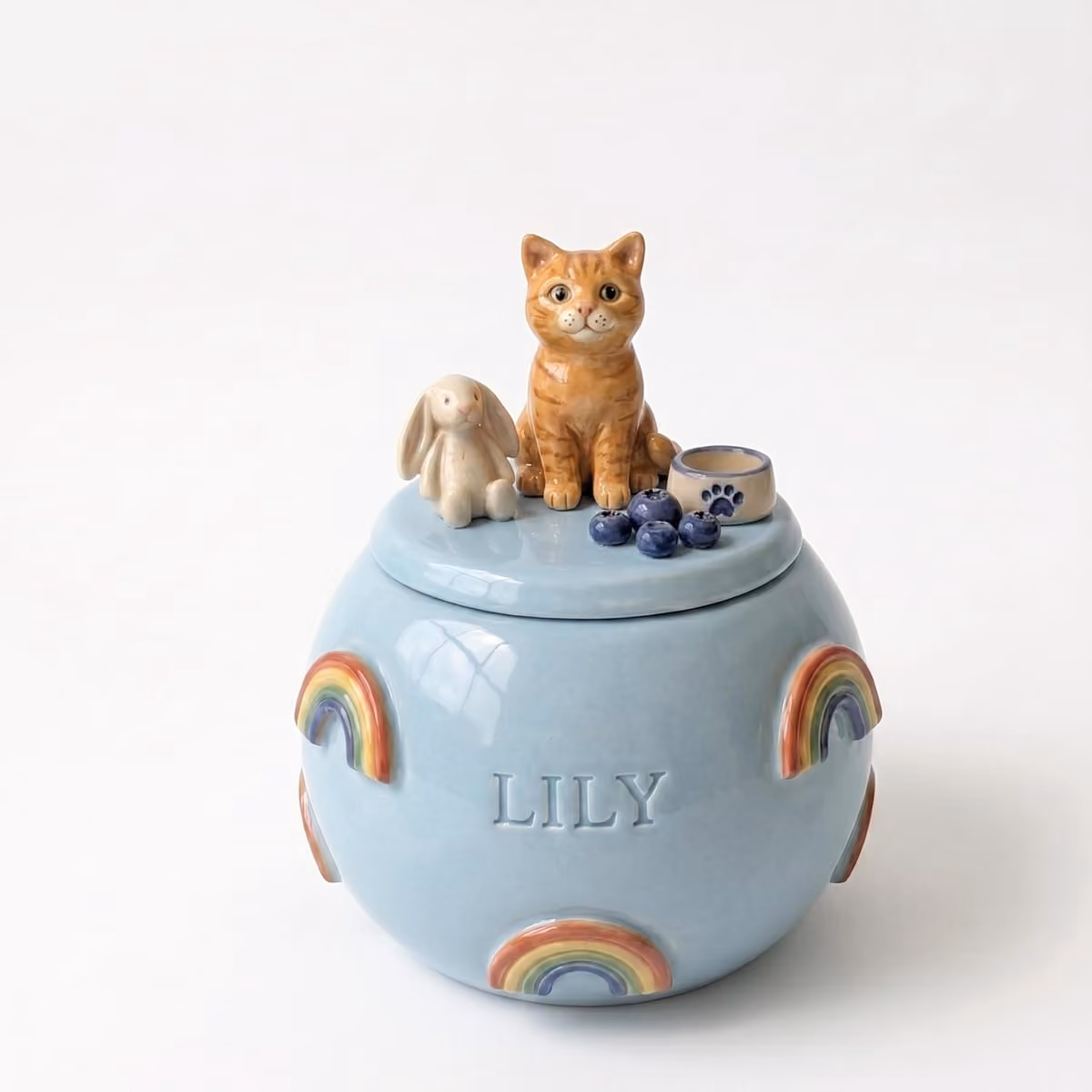 Rainbow Bridge pet urn shown next to a hand for scale