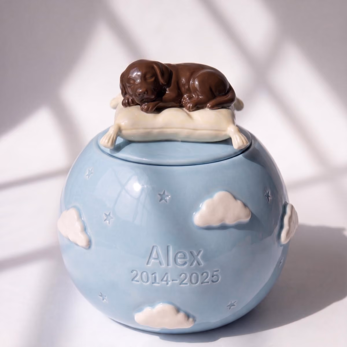 Sleeping Cloud pet urn shown next to a hand for scale