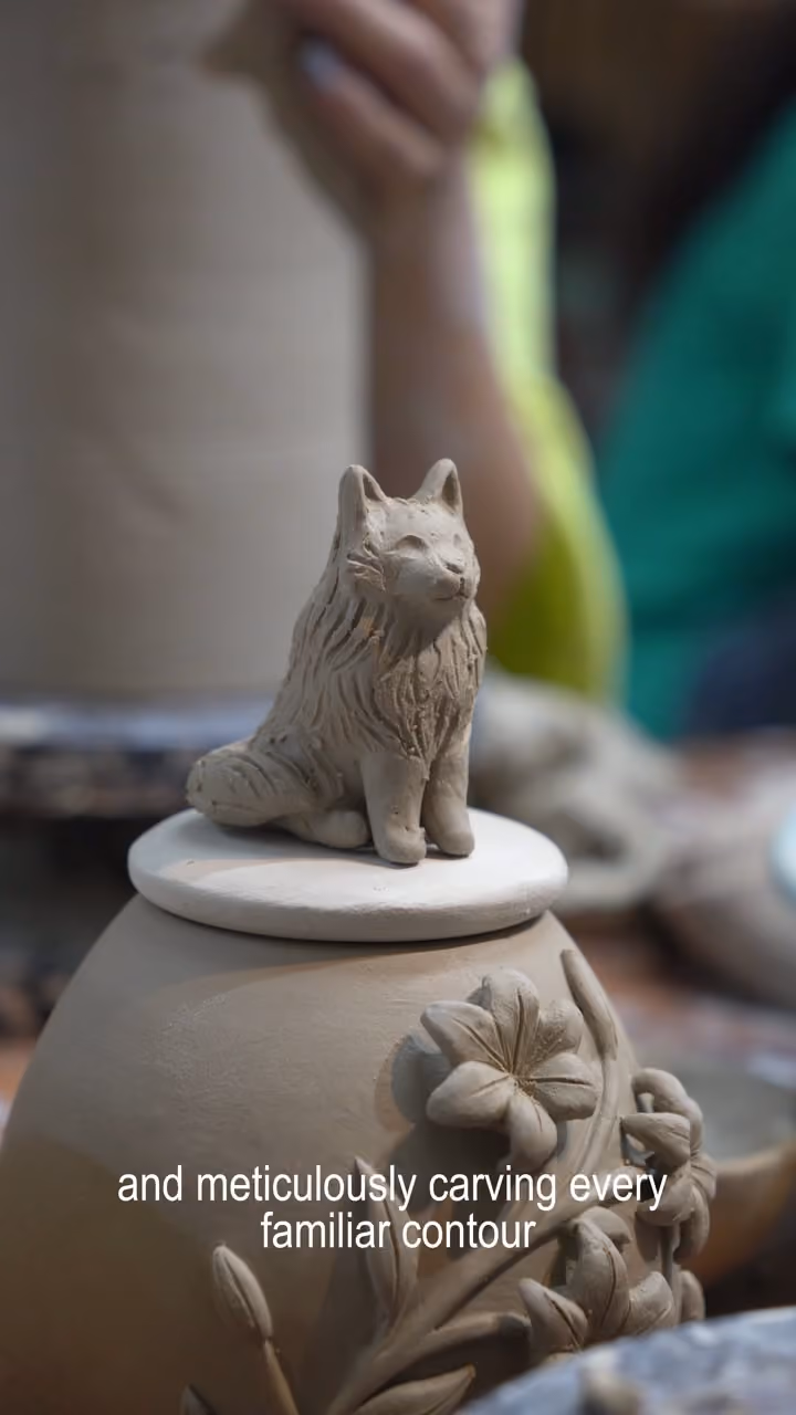 Studio film: a figurine sculpted in clay, an urn painted on the wheel, and finished urns with their figurines