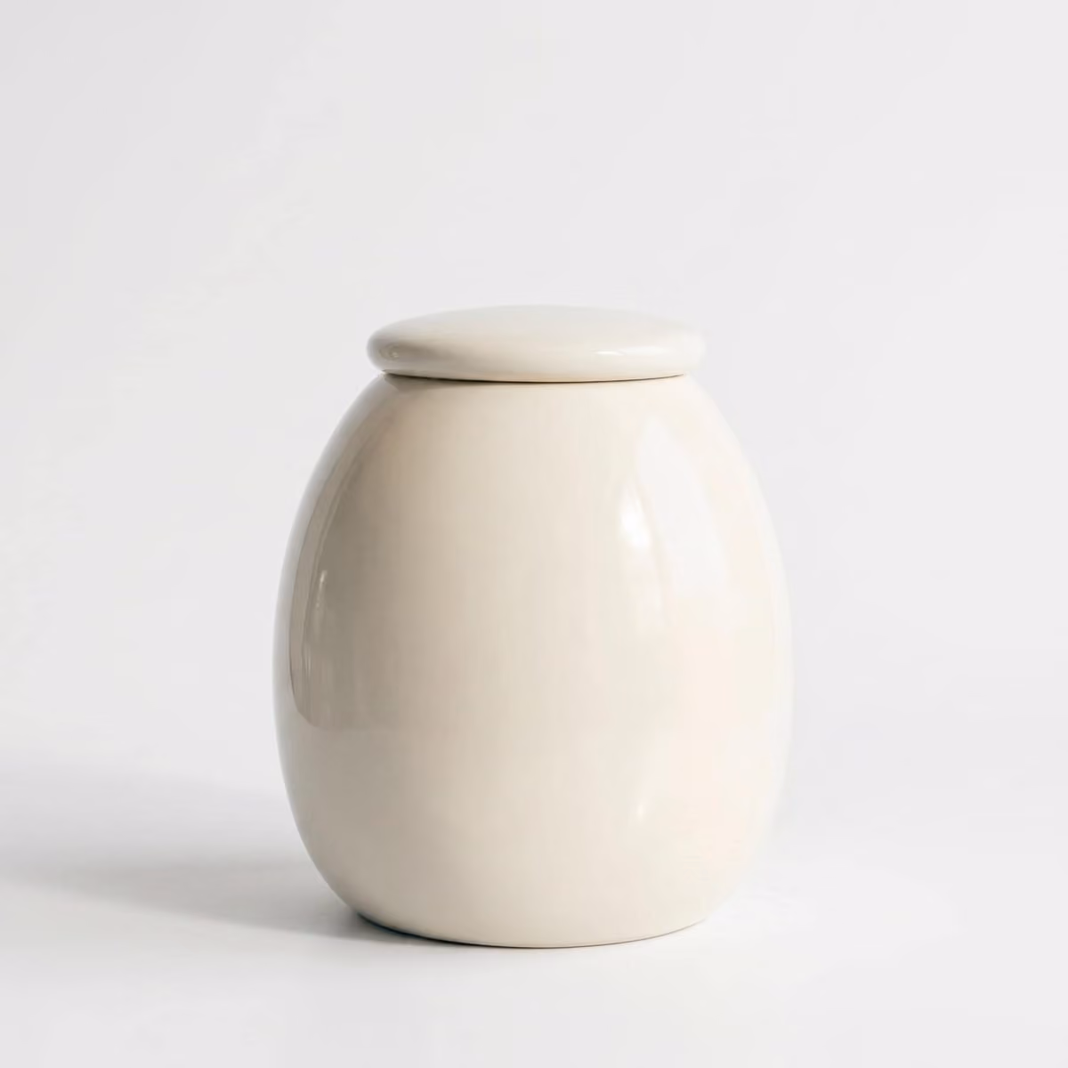Tulip pet urn shown next to a hand for scale