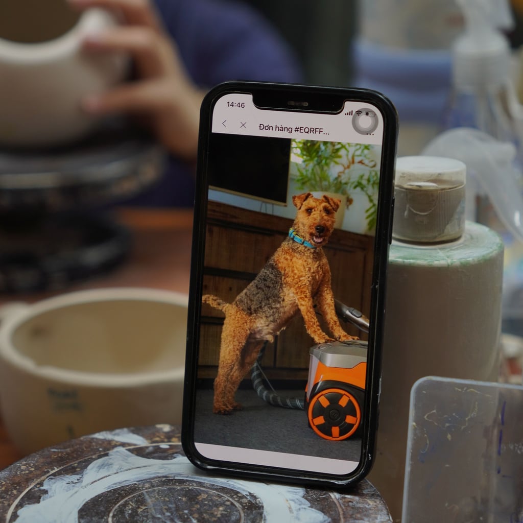 Customer’s pet reference photo open on a phone at the Pepple Studio workbench